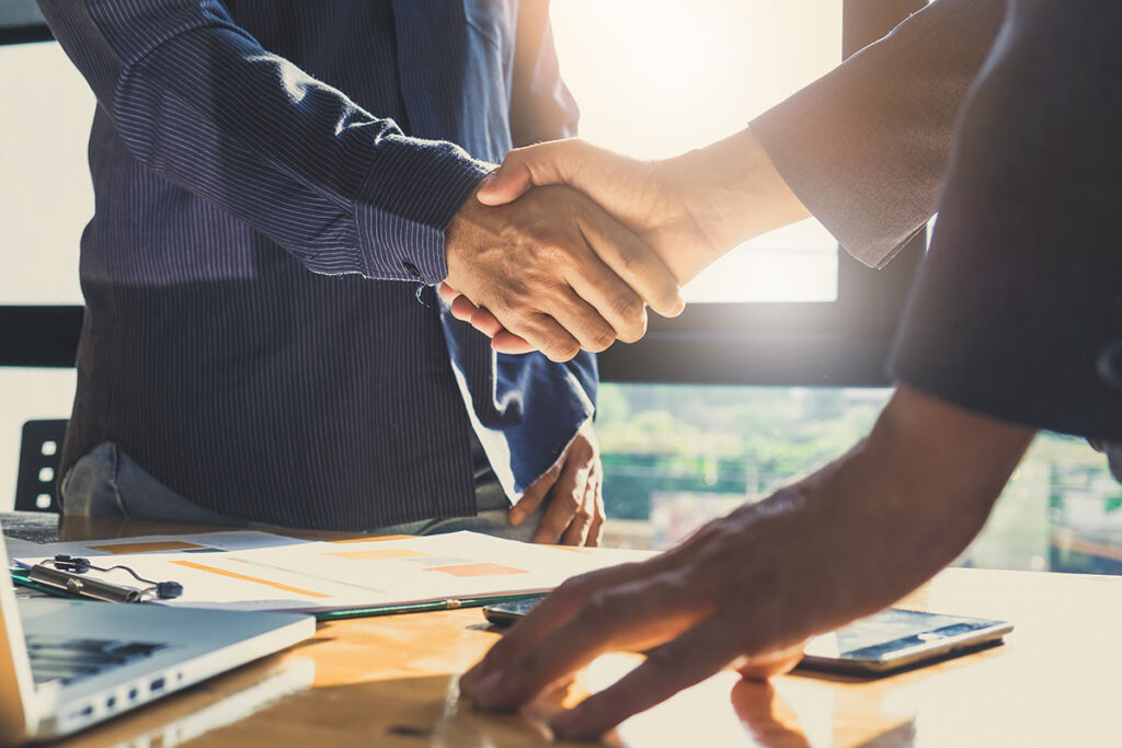corporate business men shaking hands